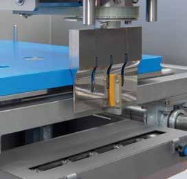 The precise slicing is accomplished by moving the cutting table in a servo driven x-y movement underneath the ultrasonic cutting blade