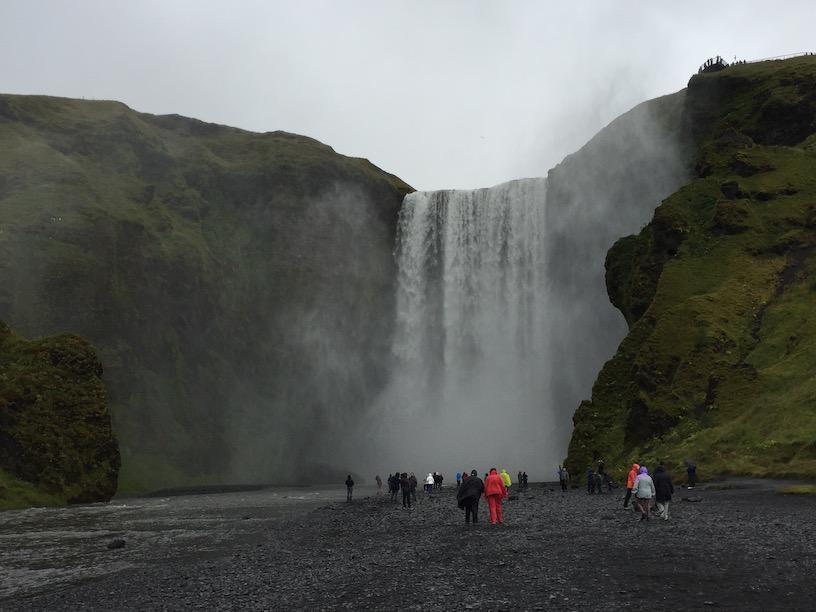 Our last stop was Seljalandsfoss, a graceful ribbon-like waterfall, again dropping from an overhanging lava cliff.