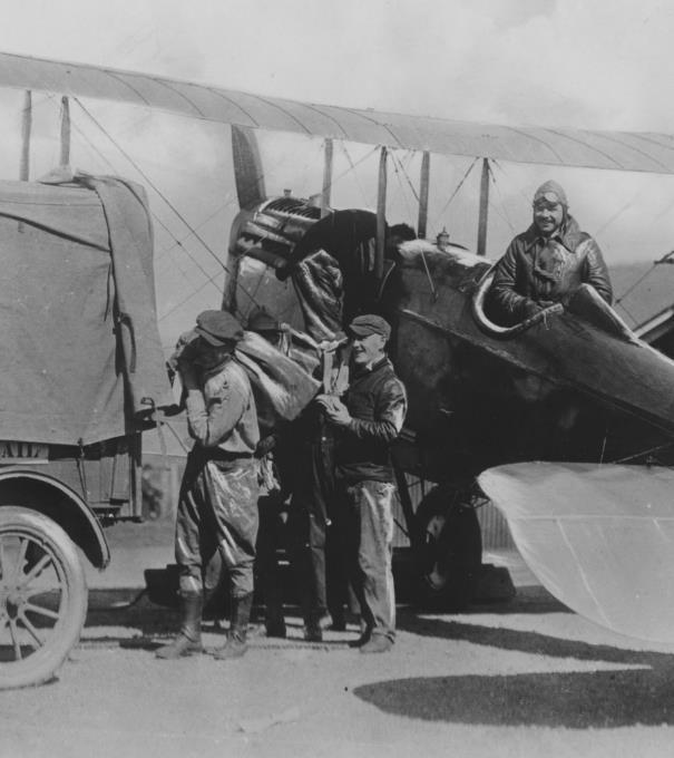 Top left: Pilot Wesley Smith watches as ground crew transfers mailbags at Bellefonte, Pennsylvania, in the 1920s.