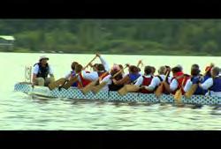 Columbia: Terrace: Group of people dragon boat racing with forest in background Clip #: 118 01:19:20:02 N