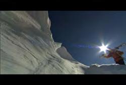 British Columbia: Pan of female skier going down mountain with sky and mountains in background 01:25:41:21 N