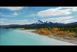 193 AB-HD-001 Alberta: Banff National Park: Low angle aerial of glacier lake with mountains in