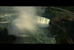 Niagara: Aerial wide shot of falls then push in on maid of mist boat on water