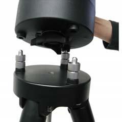 Carefully position telescope mount onto the tripod by aligning the three holes onto the