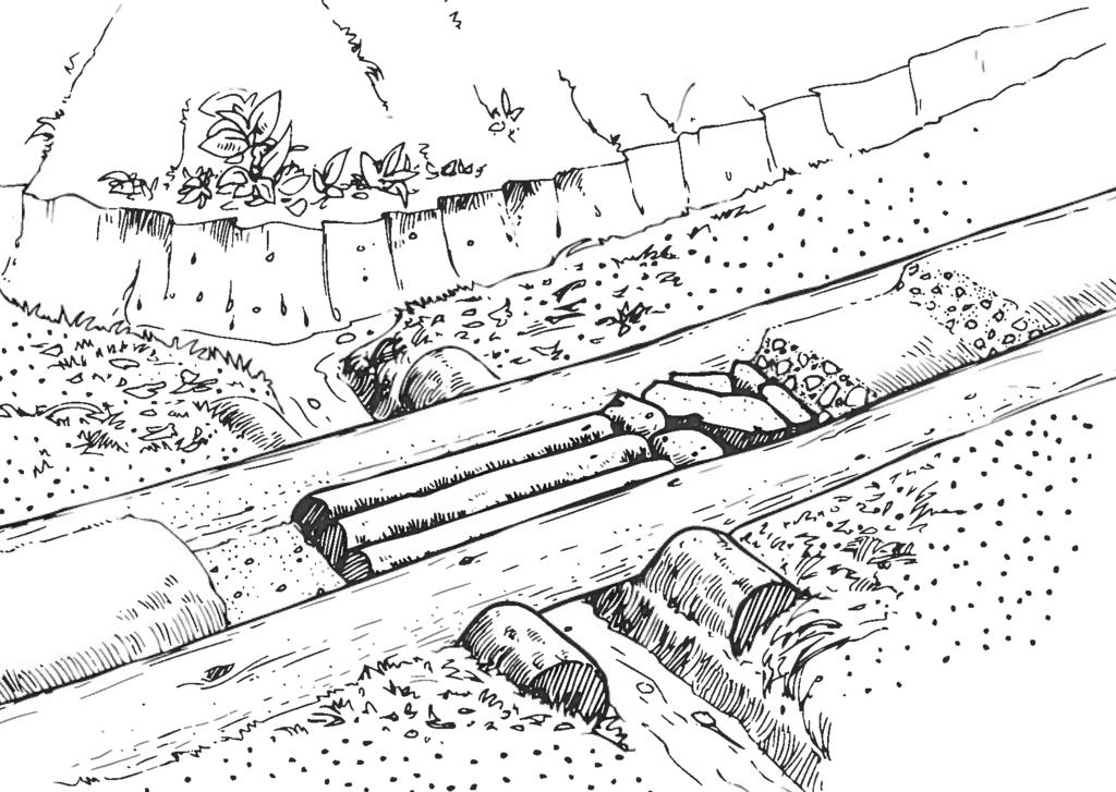 Note rock splash apron. (Image courtesy of SCA) Figure 5. A log culvert is covered with six inches of compacted mineral soil or gravel.