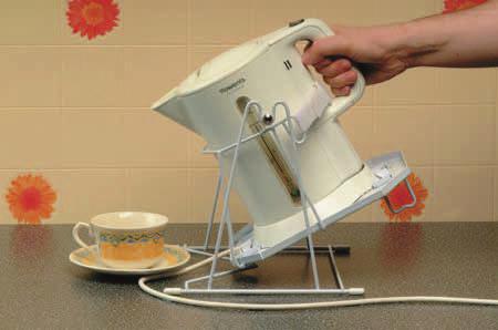 cradle that holds most styles of jug kettle, and pivots on a raised wire frame by