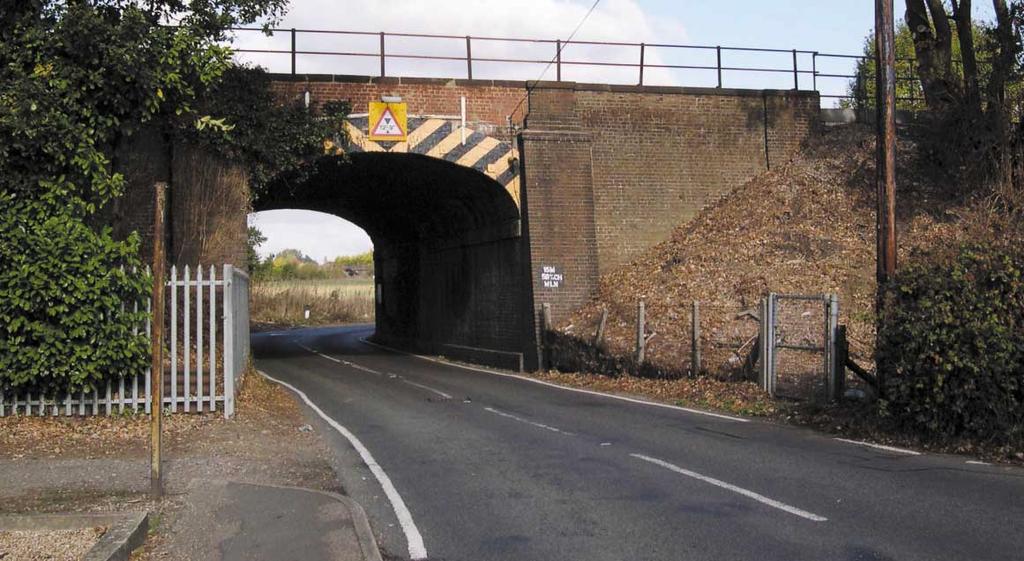 The embankment between Chequer Bridge and Dog Kennel Bridge would be widened, requiring permanent acquisition of a narrow strip of adjacent open land.