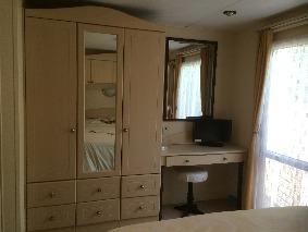 There is a dressing table, at the end of the bed, with plenty of wardrobe space and drawers and a stool. There are light controls at the bed and entrance to settle you down to sleep.