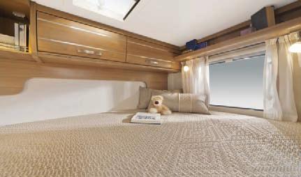02 01 View of large single lateral bed in the rear of the Exsis-i 504 with Umbria Select furniture