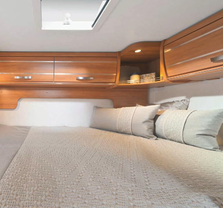 02 Double lateral bed in the rear of the Exsis-i 644 with roof storage cupboards in Trentino