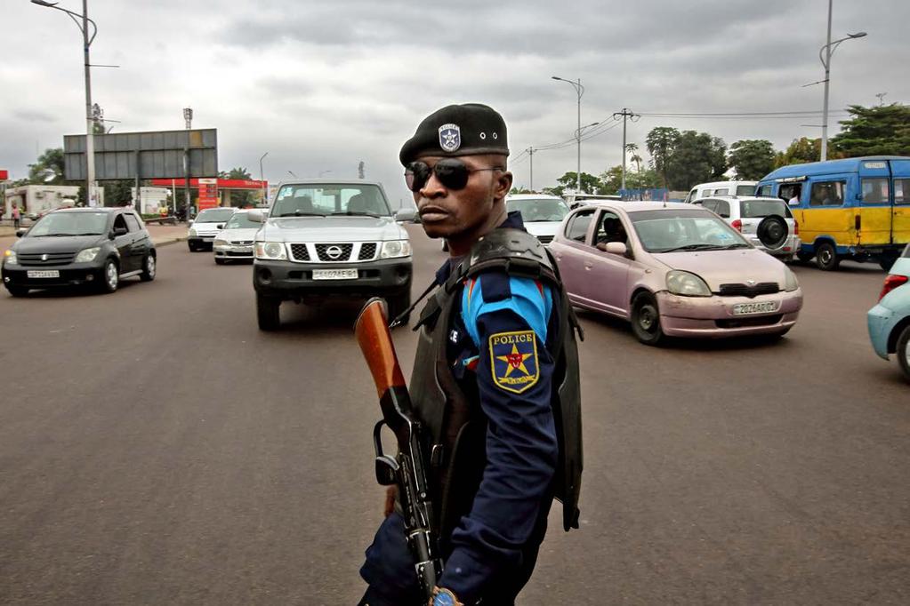 A policeman armed with a tear-gas