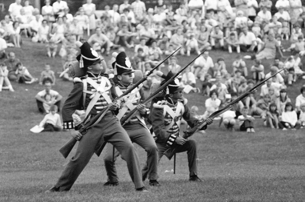 Three guardsmen perform a musket drill for onlookers in Battlefield Park, Stoney Creek, en route from Fort George to Fort York. (From The Telegram [Toronto] 16 August 1967. Photo by John Sharp.