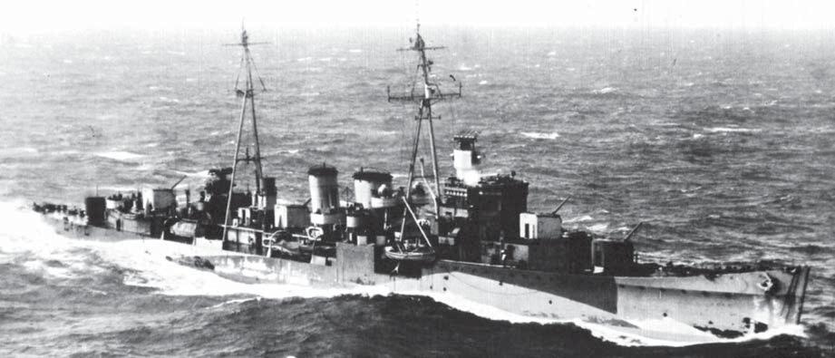 The D class cruiser HMS Delhi, photographed while in transit in the English Channel in the spring of 1943, her five American 5-inch guns trained towards the enemy-occupied coast.