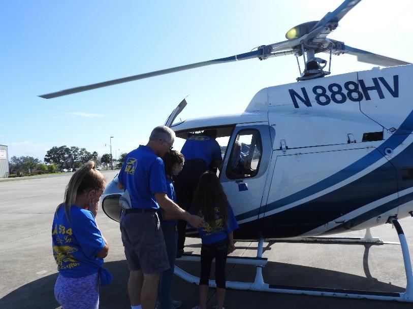 Congrats Three happy girls in their new blue EAA T-shirts just completed their helicopter ride.