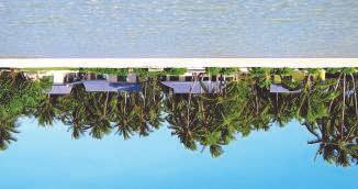The main hotel building overlooks the beach on the ocean side of the atoll and has 24 simple but
