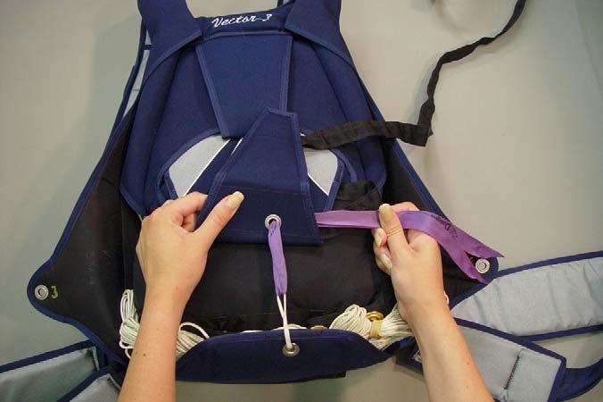 3. Use your knees or feet to walk on the bag, squeezing air out and distributing the bulk until the packed canopy is uniformly distributed within the bag. 8.