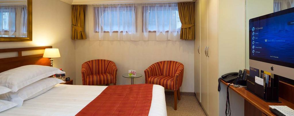 Stateroom: Category D Size: 170 sq. ft. with Fixed Windows Delight in the amenities of this well-appointed room that offers a scenic view from fixed windows just above a sitting area.