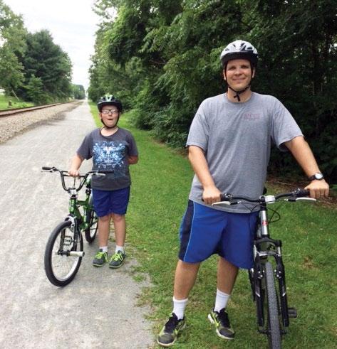 Photos - Joanne Caffrey Volunteers so that People at Work... can enjoy a great recreational resource Charles Grybosky and his son Owen enjoy a ride on the Five Star Trail.