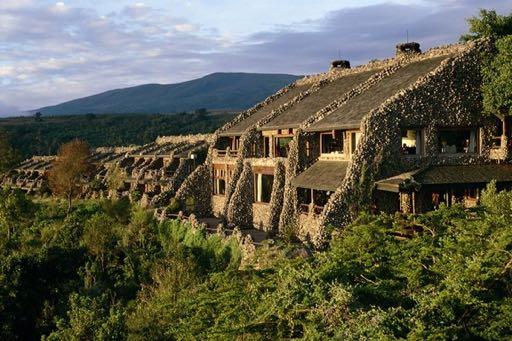 streaked cliff above the flamingo-frosted expanse of Lake Manyara s gleaming alkaline waters, the Lodge commands
