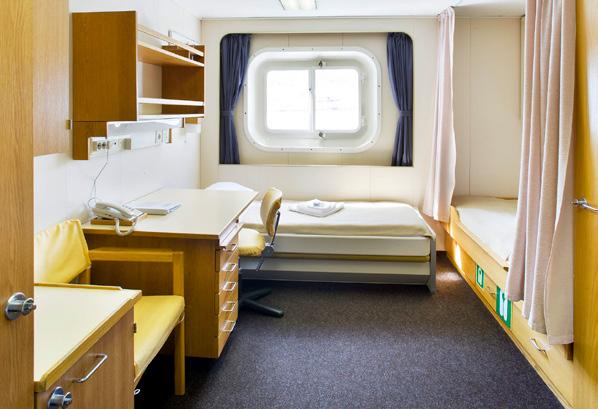 One lower berth can be converted to a comfortable sofa during the day. Washroom facilities are shared.