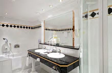fabrics. The elegant bathroom is equipped with a large bathtub, shower, double washbasin and WC.