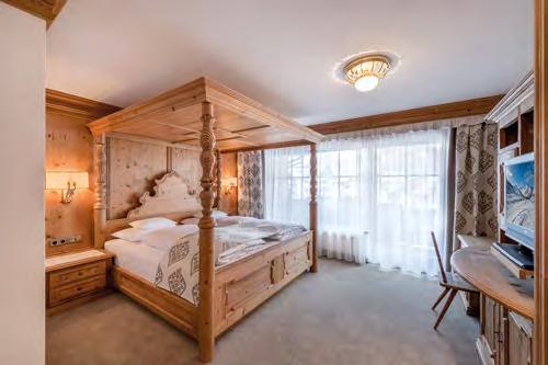 The master bedroom boasts a romantic four-poster bed and a large bathroom with a bathtub, shower, double washbasin, WC and private sauna.