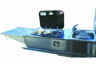 Fitted beneath the club lounge and accessible from outside the camper trailer at the rear of the vehicle this slide out kitchen incorporates a sink with an electric pump operated tap and a two burner