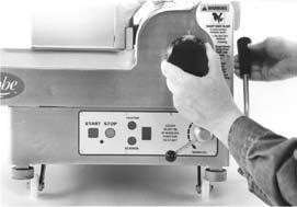 Automatic slicers have a lift lever that raises the slicer to allow cleaning underneath. a. With the auto engage lever in Manual position, push the chute arm to the back of the slicer.