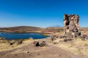 of Lake Umayo near Puno in Peru. The ruins are built above ground in tower-like structures called chullpas.