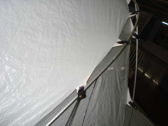 The section of pipes corresponding to the walls are attached to the tent with straps, and secured with Velcro.