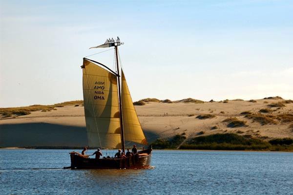After a short crossing the Curonian Lagoon by ferry, you reach the Curonian Spit (UNESCO site), a sandy stretch of land,