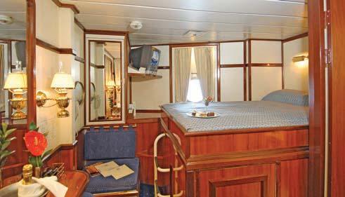 CATEGORY 5 - CLIPPER & COMMODORE DECK Outside cabin with raised double bed, twin/double/triple beds, marble bathroom with shower.