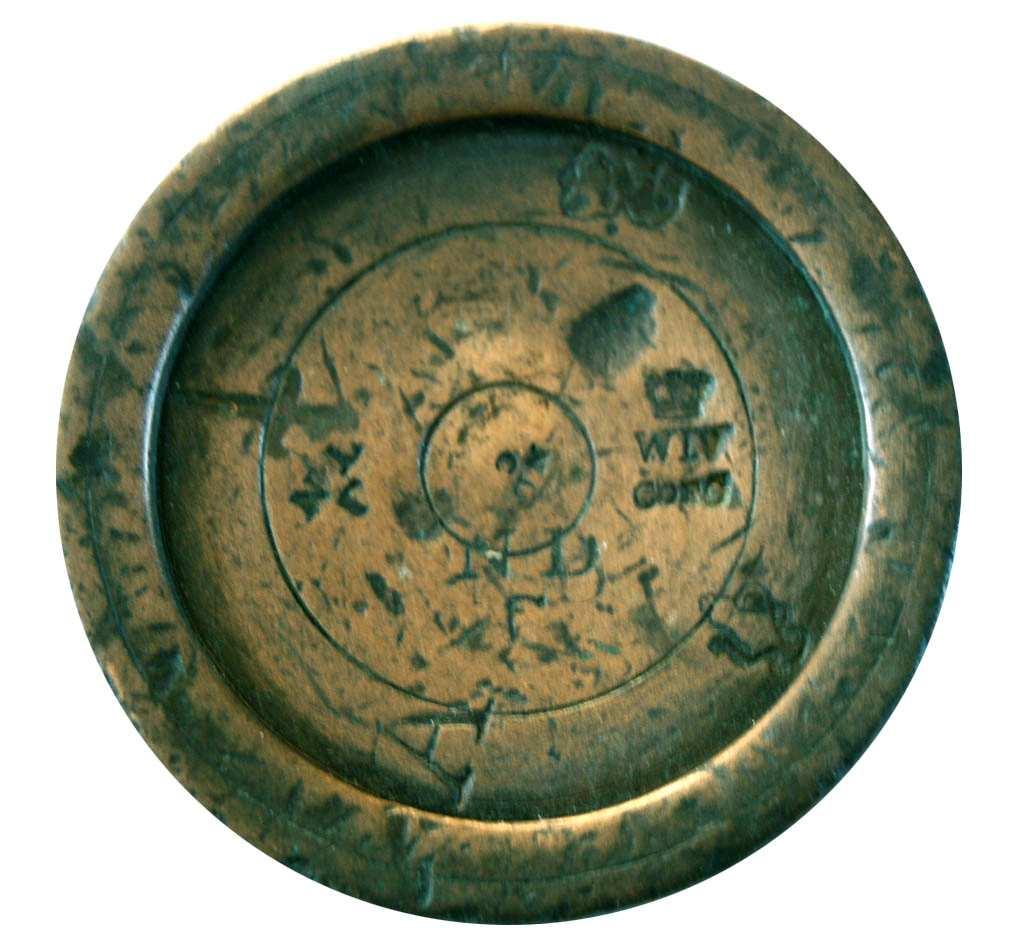 A bronze weight with the original Cambridgeshire mark, W IV above C OF C.