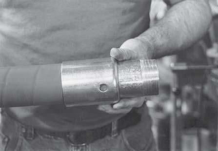 of the hose until the turned over portion of the ferrule rests on the ring of the stem.