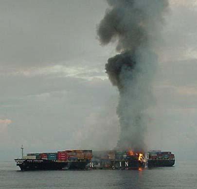 Photo 6. The M/V HANJIN PENNSYLVANIA (port) after the explosion of Nov 15 th in hold six. Fires continue to burn above hold six and smolder above hold four.