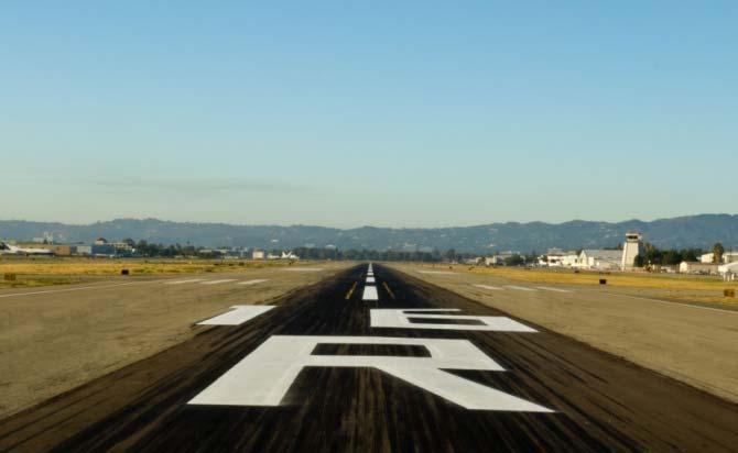 Runway surface markings include centerline stripes,