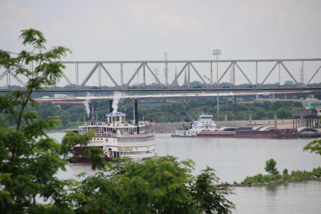 As the L&I train cleared the lift bridge, a look up the canal brought into view the excursion boat Belle of Louisville waiting to dock on the Kentucky shore and the 9,000 hp.