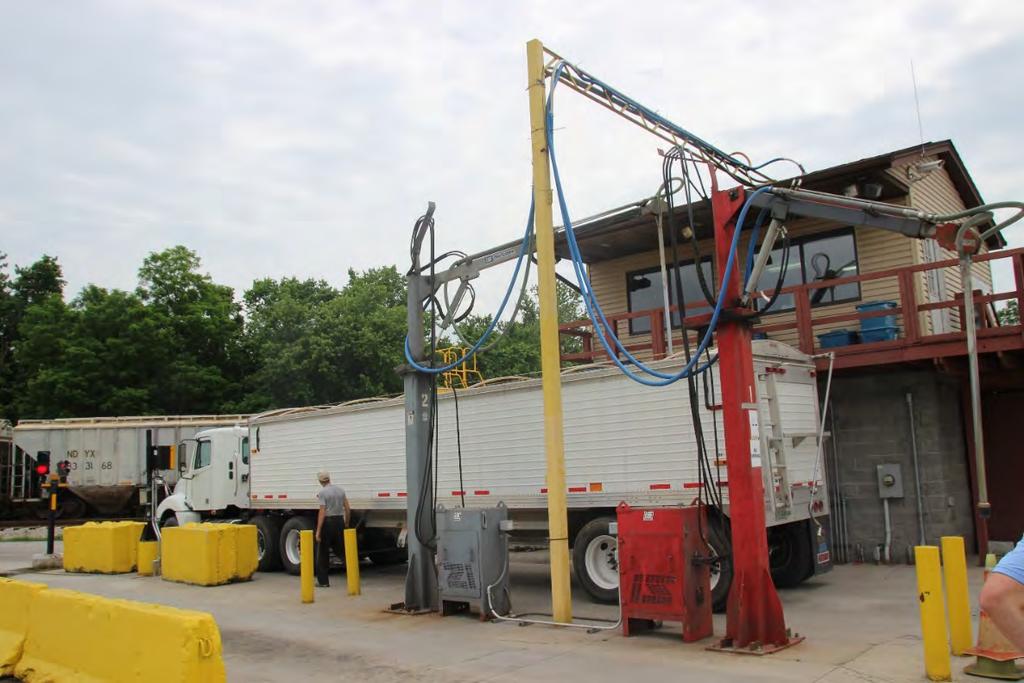 As the trucks enter Consolidated Grain, they stop at the grain sampling station. A long pole, like that on the right, is inserted into the cargo at random locations.