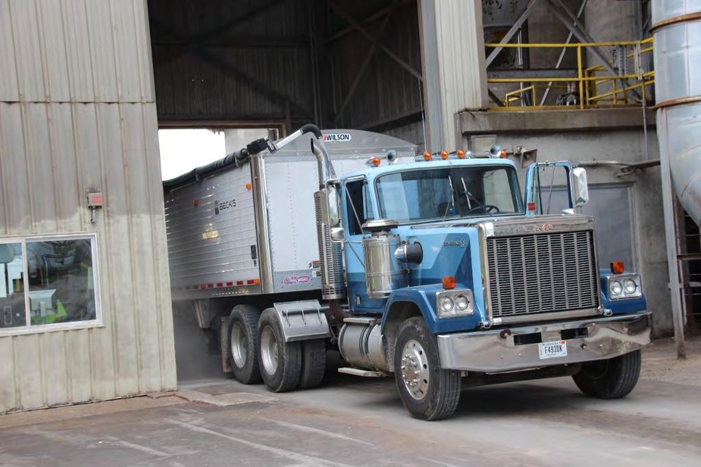 A truck is preparing to dump its load of grain.