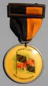Lot # 70-2 sided Celluloid Badge with Orange and Black ribbon suspended from brass shell top. The celluloid hanger picturing the "Maryland." State flag with "Pan-American" below.