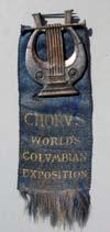 Lot # 23 - Hanging Badge for the "Chorus World's Columbian Exposition" with a figural brass liar at the top. The ribbon is blue with gold writing. Size: 4 5/8" high by 1 1/2" wide.