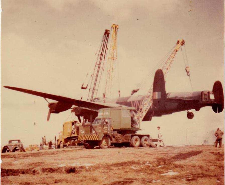 On 11 April 1962, Lancaster FM136 was lifted into position by three large cranes, supervised by ex-lancaster pilot Red Whittit, of Dominion Bridge, Calgary.