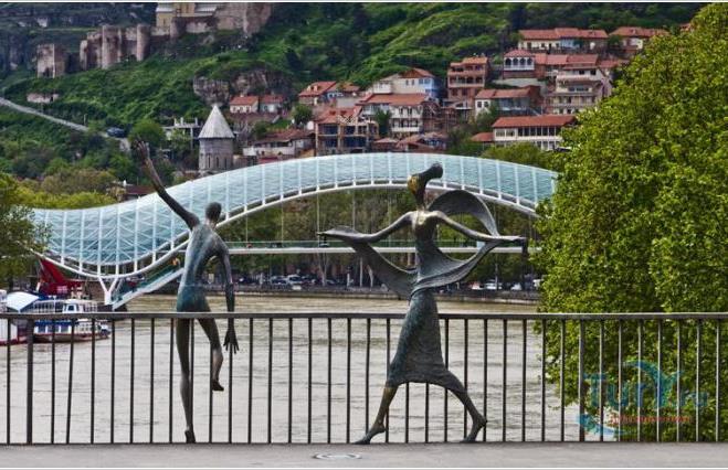 up by cable route to an ancient fortress, overlooking Tbilisi and the Kura River Walk along old city and Abanotubani (sulfuric baths district) Monument to Sergei Parajanov Bridge of Peace (bow-shaped