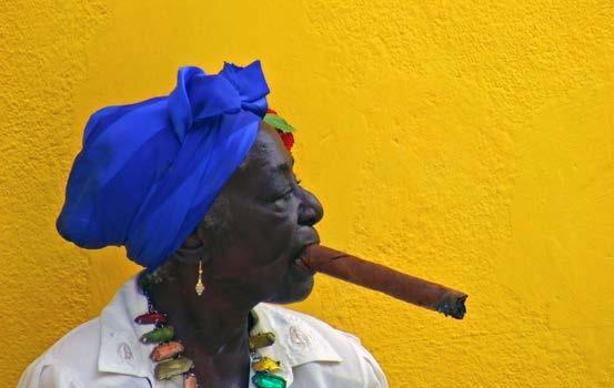 Lady smoking her cigar in the Vieja district, Havana David Steele INCLUDED Private coach transportation throughout and other transportation as per itinerary (coco taxi, vintage