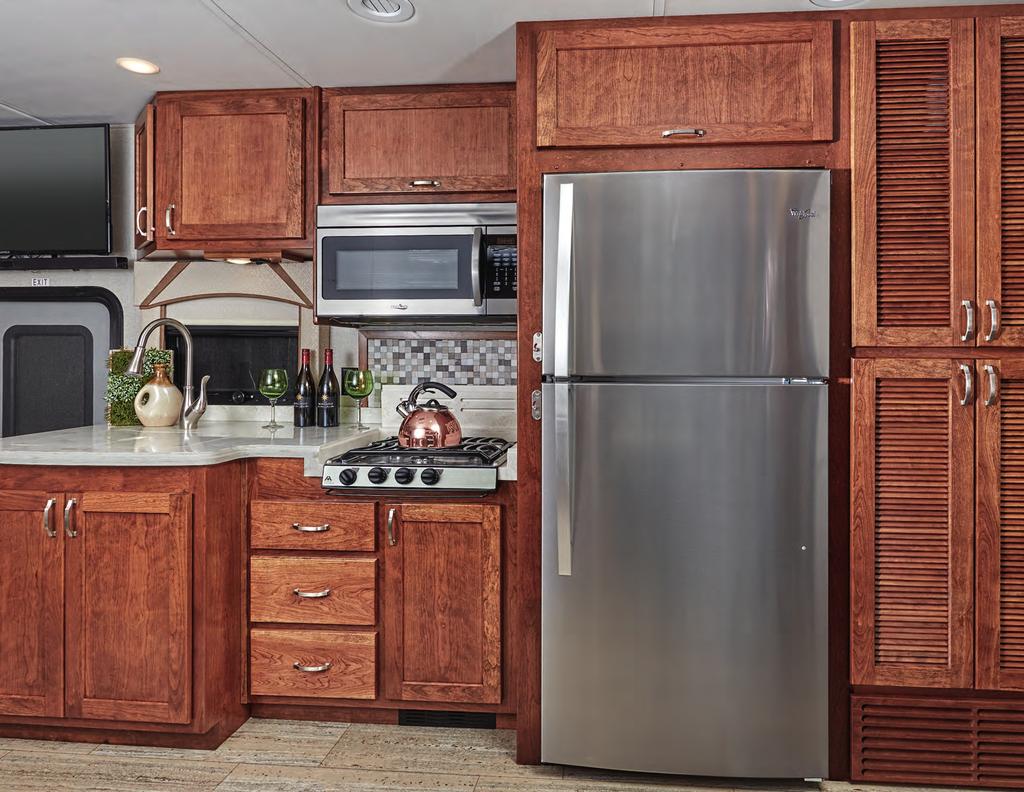 LEGENDARY RENEGADE LUXURY VALENCIA The kitchen of the Valencia features solid Cherry hardwood cabinets with plenty of storage and soft closing drawers, and topped with LG HiMacs polished solid