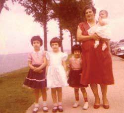 Pela, Goly, me, and Mami, who is holding Cristi Goly, Pela, Cristi, and Abuelita with our station wagon In this photo, you can see Mami, me, and my sisters. We are next to Lake Michigan in Chicago.