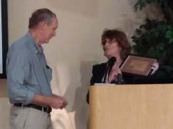 T H E P E T R O G L Y P H / December 2016 Left - Glenda Simmons presenting the 2016 AAS Professional Archaeologist Award to Dr. David Abbott on Nov. 18.