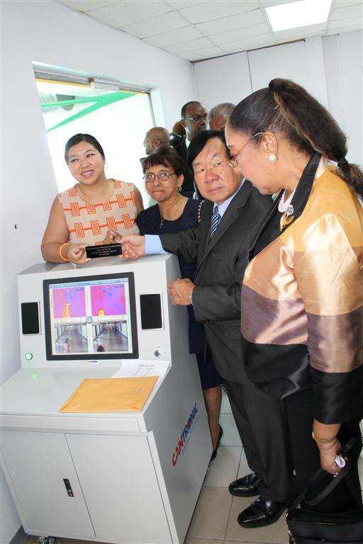National Security as well as members of the Vincent HoSang Family Foundation look on. The body scanning machine is valued at US$38,000.