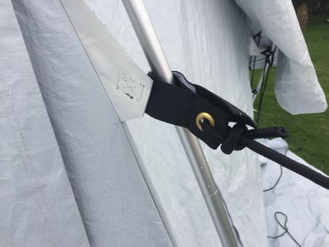 Both solutios (as shown in the picture) are acceptable as long as they comply with the tent s lifespan. The guy point needs to be behind the front pole to push the pole forward.