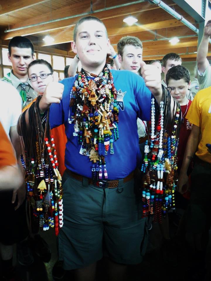 2014 Vice Chief of Administration Austin Weber with 147 coup thongs draped on his arms and neck.